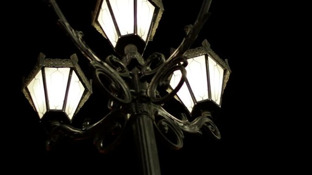The night street of the city. Street light with three lamps in a classical style
