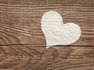 heart of flour on old wooden board