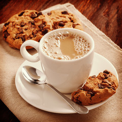 Fragrant coffee in a white shirt and biscuits on the table
