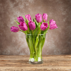 Beautiful bouquet of tulips on the old board