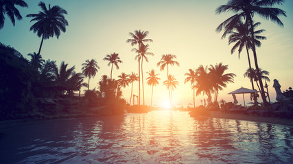 Fototapeta na wymiar Amazing sunset on a tropical coast with palm trees.