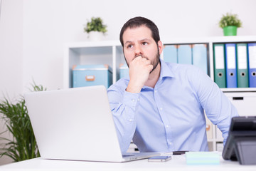 Geschäftsmann im Büro bei Problemlösung nachdenklich