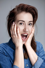 Portrait of young woman with shocked facial expression
