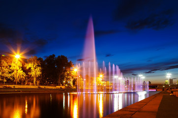 illuminated in different colors at night fountains Plotinka. Summer Yekaterinburg downtown.