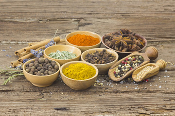 Variety of spices on wooden background