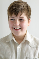 Portrait of smiling teenager boy in a bright shirt