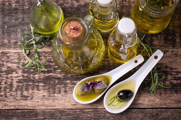Oils on vintage wooden background . healthy food