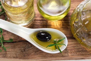 Oils on vintage wooden background . healthy food