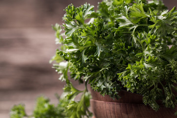 Fototapeta premium tied fresh parsley on wooden surface, healthy food