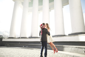 Beautiful couple, bride and groom posing near big white column