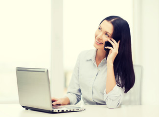 businesswoman with laptop and cell phone