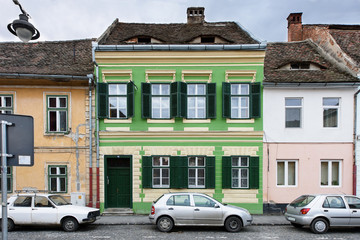 Fototapeta na wymiar Downtown street in Sibiu with dark sky and colored houses, Romania