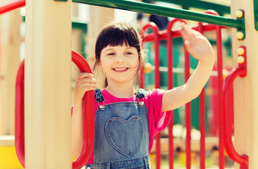 Obraz premium happy little girl climbing on children playground