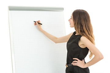 Business woman in front of a white board and writing with a marker