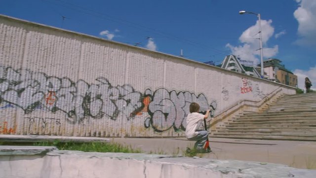 Boy riding scooter