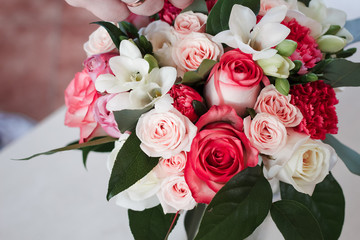a bridal bouquet of roses, freesia, carnations and fat. top view