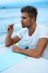 Handsome Man Drinking Glass Wine In Sea Restaurant In Summer