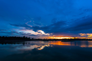 Breathtaking sunset with blue sky over lake