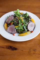 Fresh salad with ham and greens
