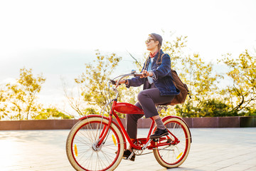 female riding vintage bicycle in park 