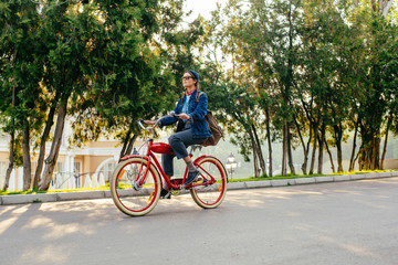 female riding vintage bicycle in park 