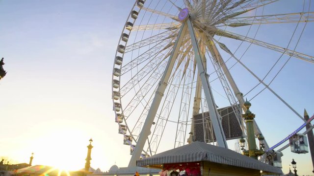 Sun ray penetrating giant rotating construction of observation wheel, theme park
