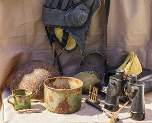 Objects of the Great Patriotic War. Helmet, headset, bowler, glasses, cup, field cap, canteen,...