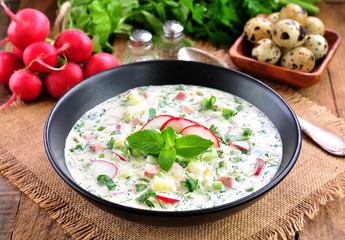 Cold summer soup with radish, cucumber, dill, parsley boiled eggs and potatoes. Russian traditions.