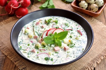 Cold summer soup with radish, cucumber, dill, parsley boiled eggs and potatoes. Russian traditions.