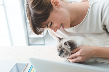 Woman cuddling her cat