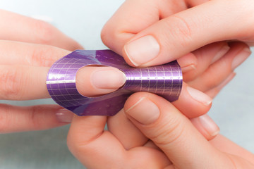 Manicure. Master make nail extension. Finger closeup
