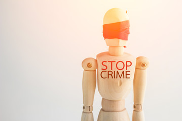 wood man figure blind with red ribbon with word stop crime.jpg