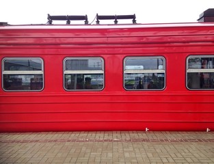 Detail of red train at platform of train station