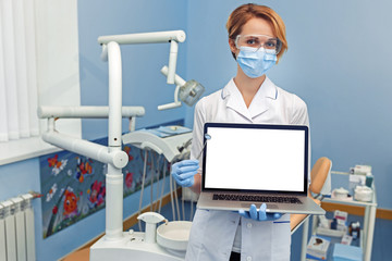 Dentist holding a laptop with empty place for your image