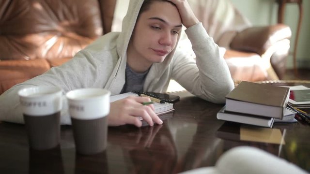 Tired student wakes up from a sleep.