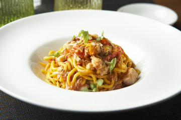 Fresh spaghetti with white fish ragout, capers and orange zest