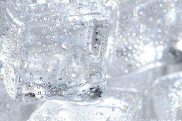 Macro detail of ice cubes with water droplet