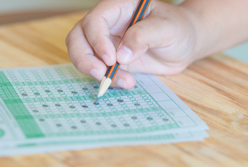 student testing in exercise, exams answer sheets on table, educa