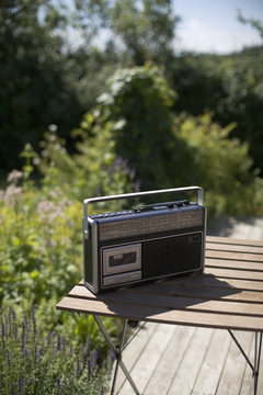 A radio on a table in a garden, Sweden.