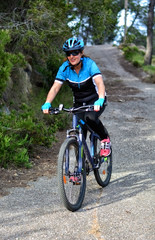 Obraz premium happy woman riding mountain bike