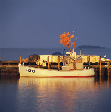 Boat by jetty in sea