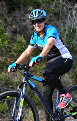 Obraz premium happy woman riding mountain bike