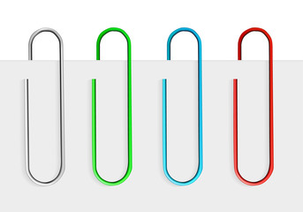 Colored paper clips on paper.