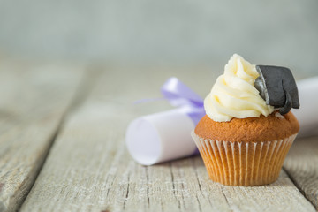 Graduation concept - cupcake with academic cap
