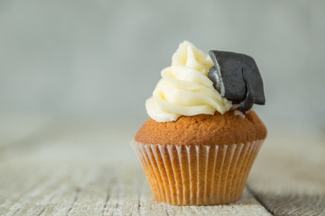 Graduation concept - cupcake with academic cap