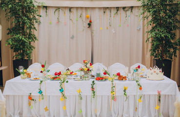 stylish luxury decorated table with flowers and delicious food, celebration wedding, catering in the restaurant