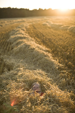 A girl playing on a field in the sun, Sweden.