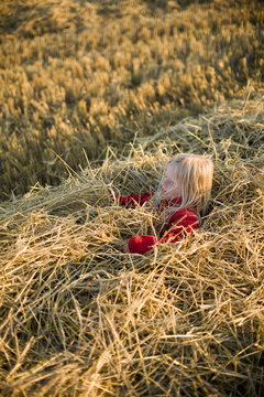 A blond girl playing on a field, Sweden.