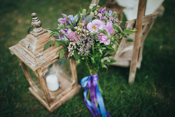 bridal bouquet of flowers and greenery is in the area for a wedding ceremony