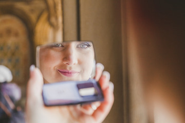 Gorgeous beautiful bride with green eyes mirror reflection face closeup